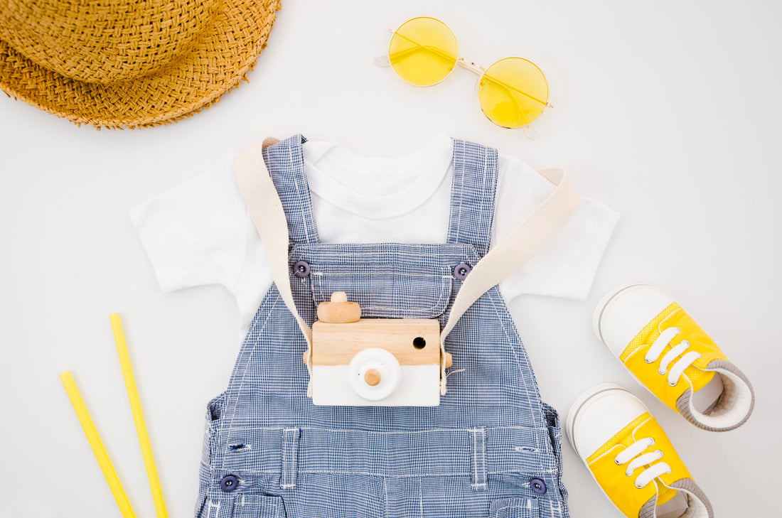 flat-lay-baby-clothes-with-photo-camera